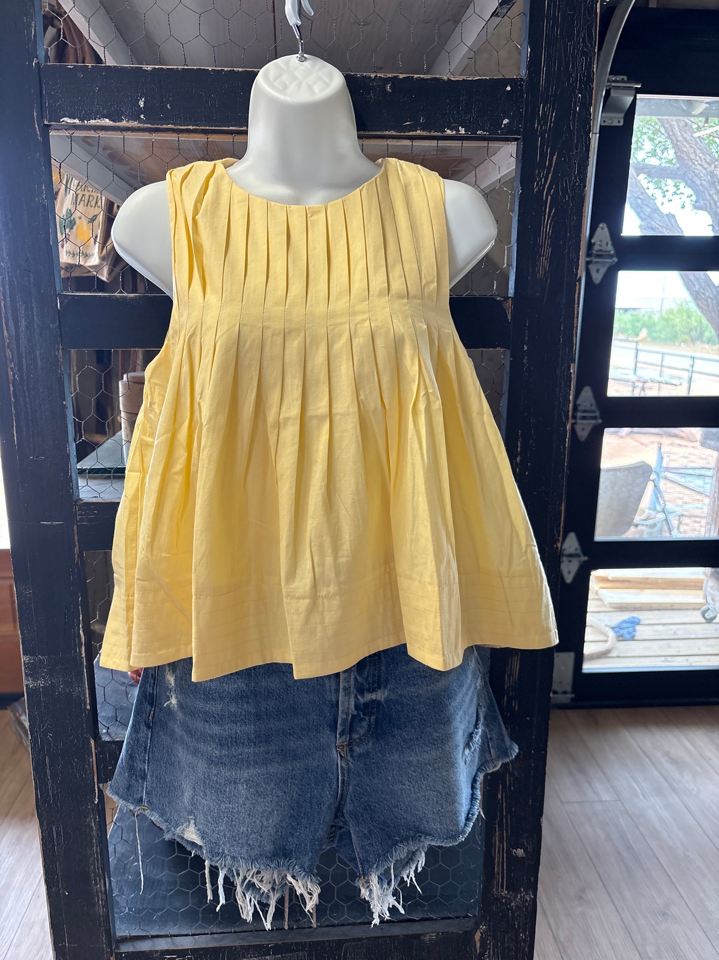 Yellow pleated blouse